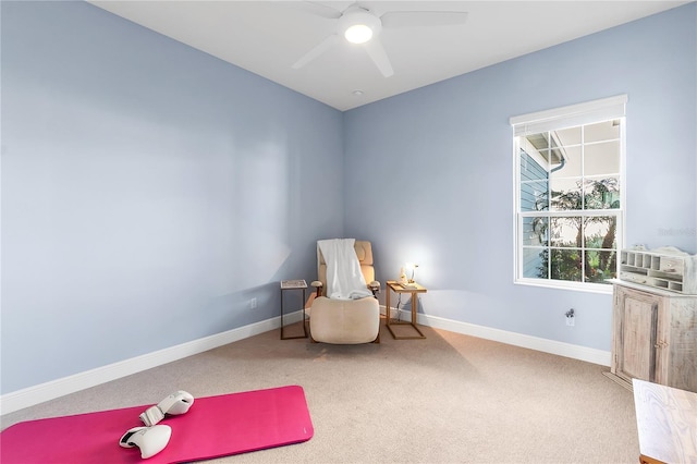 sitting room with ceiling fan and carpet floors