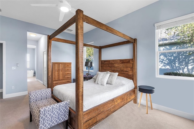 carpeted bedroom with connected bathroom and ceiling fan