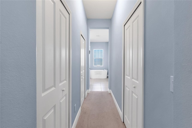 corridor with light tile patterned floors