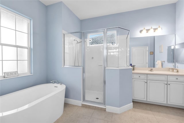 bathroom featuring plus walk in shower, vanity, tile patterned flooring, and plenty of natural light