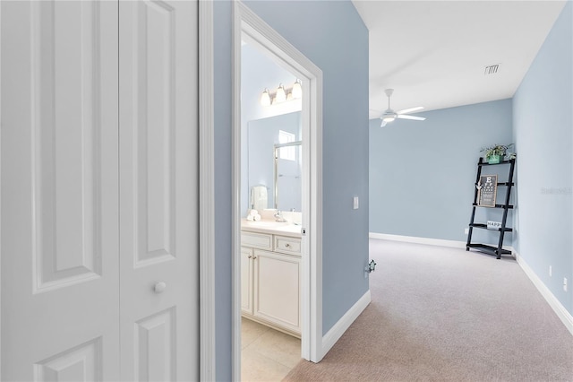 corridor featuring light colored carpet