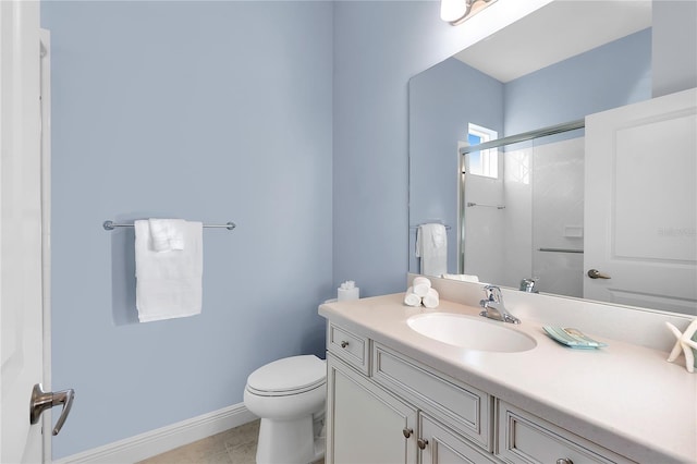 bathroom with tile patterned floors, vanity, a shower with shower door, and toilet