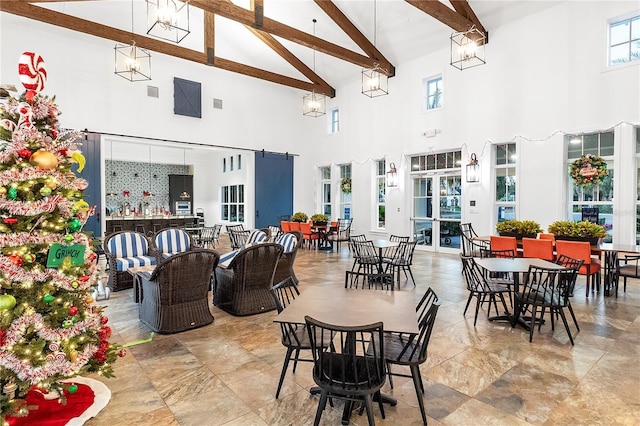 dining room featuring beamed ceiling and high vaulted ceiling