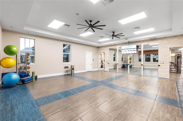 interior space with ceiling fan and a tray ceiling