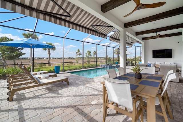 view of pool featuring ceiling fan, a patio, and glass enclosure