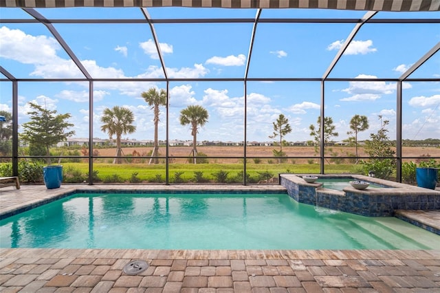 view of swimming pool featuring an in ground hot tub, a patio, and a lanai