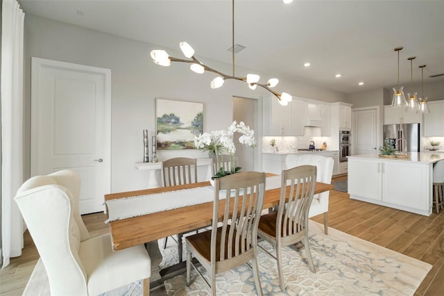 dining space with light hardwood / wood-style floors