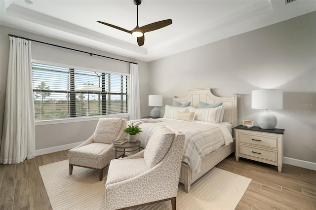 bedroom featuring a raised ceiling and ceiling fan