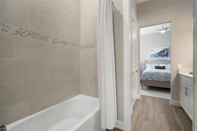 bathroom featuring ceiling fan, shower / tub combo with curtain, and vanity