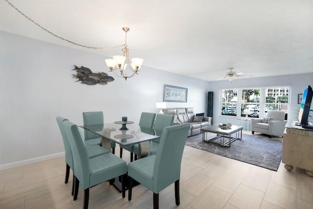 dining room with ceiling fan with notable chandelier