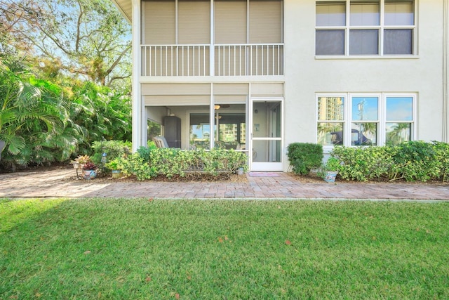 view of exterior entry featuring a lawn