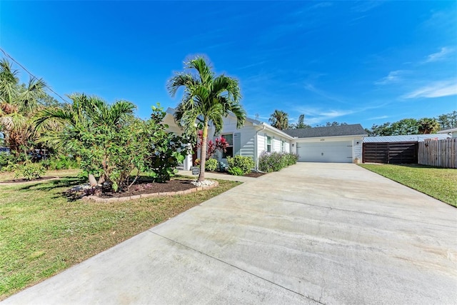 view of front of property featuring a front yard and a garage