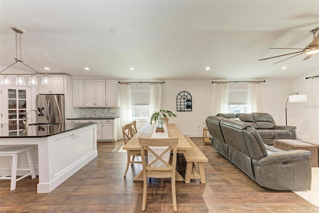 dining space featuring sink, hardwood / wood-style flooring, a wealth of natural light, and ceiling fan