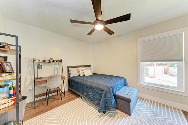 bedroom with ceiling fan and wood-type flooring