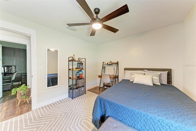 bedroom with hardwood / wood-style flooring and ceiling fan