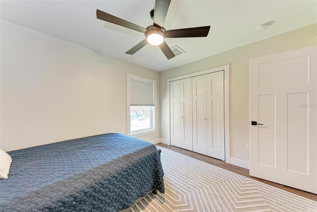 bedroom featuring ceiling fan, a closet, and wood-type flooring