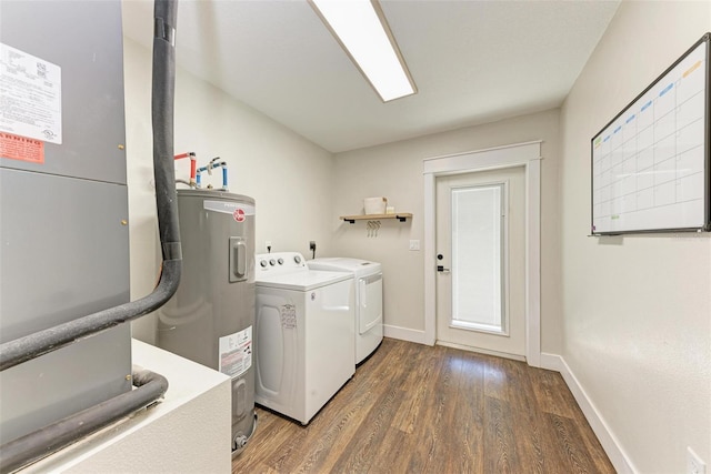 laundry room featuring heating unit, electric water heater, dark hardwood / wood-style flooring, and independent washer and dryer