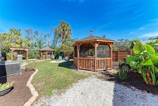 view of yard featuring a gazebo and central air condition unit