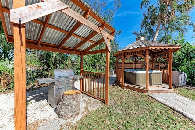 view of patio featuring a gazebo, area for grilling, and a hot tub