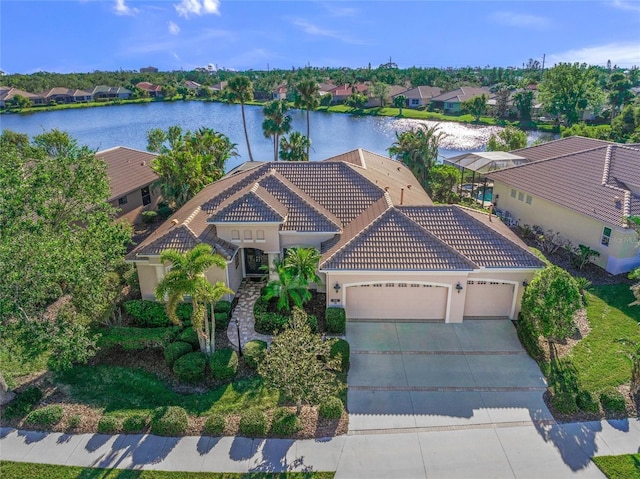 view of front of house with a garage and a water view