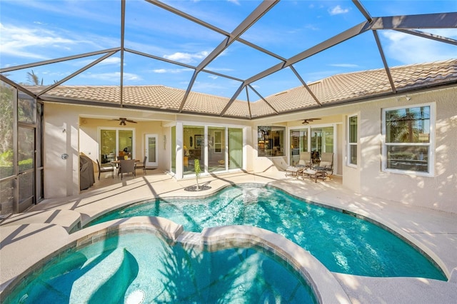 view of swimming pool featuring a patio, ceiling fan, and a lanai