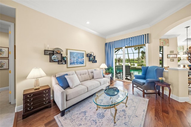 living room with dark hardwood / wood-style floors and ornamental molding