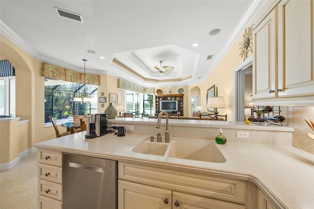 kitchen with dishwasher, a tray ceiling, ornamental molding, and sink