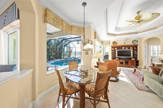 dining room featuring light tile patterned floors, a raised ceiling, ceiling fan, and crown molding