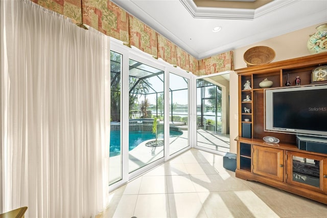 doorway featuring a raised ceiling, light tile patterned floors, and ornamental molding