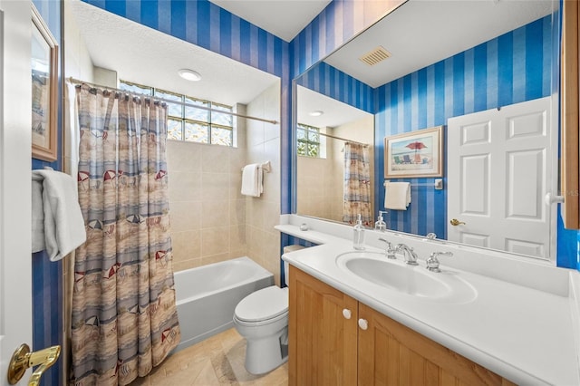 full bathroom featuring vanity, tile patterned floors, toilet, a textured ceiling, and shower / tub combo