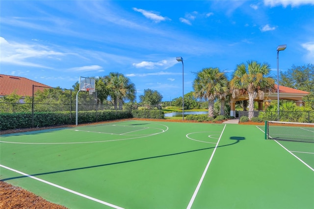 view of basketball court with a water view