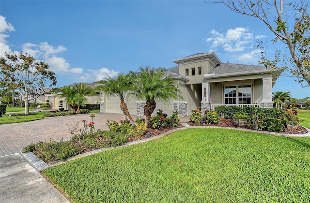 view of front of home with a front yard and a garage