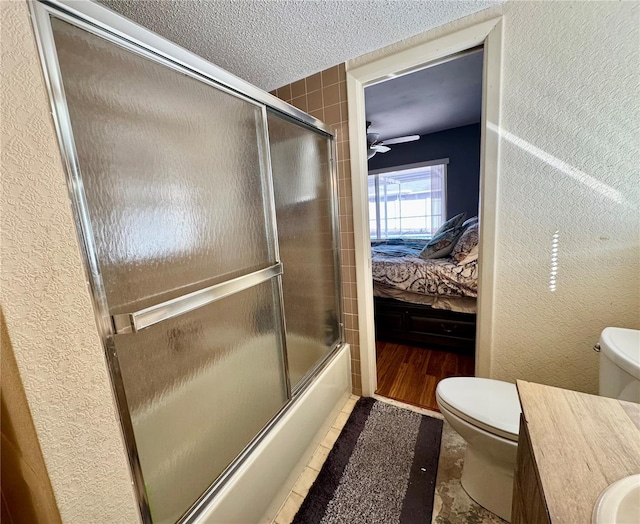 full bathroom featuring vanity, ceiling fan, toilet, and enclosed tub / shower combo