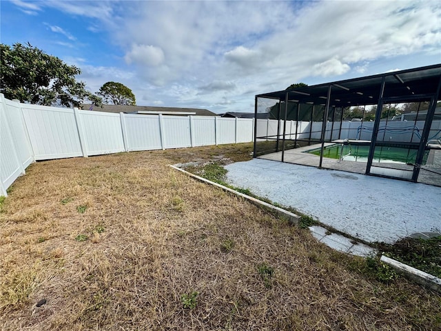 view of yard with a fenced in pool and a patio