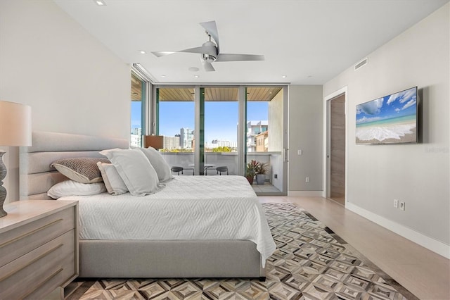 bedroom featuring ceiling fan, floor to ceiling windows, access to exterior, and light wood-type flooring