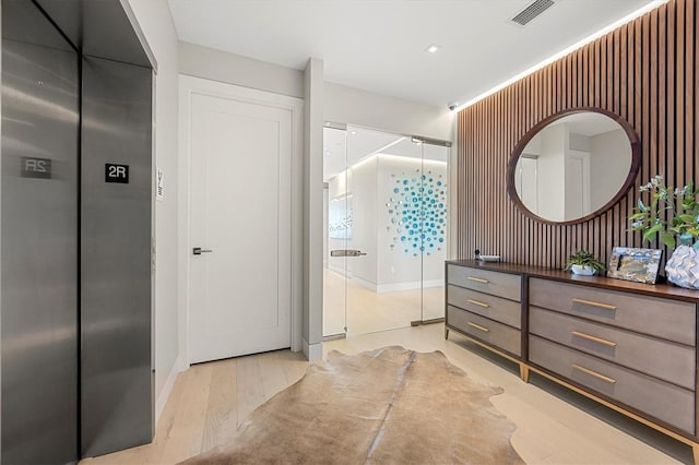 bathroom with vanity, wood-type flooring, and elevator