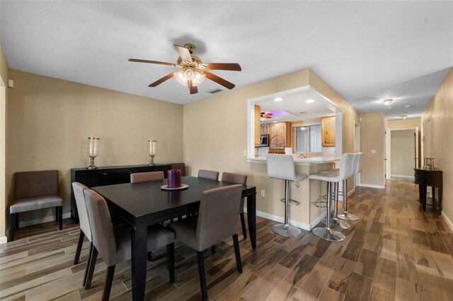 dining room featuring ceiling fan and hardwood / wood-style flooring