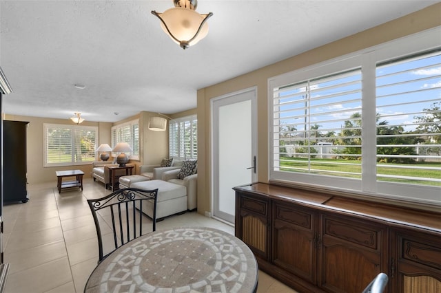 living room with light tile patterned flooring and a textured ceiling