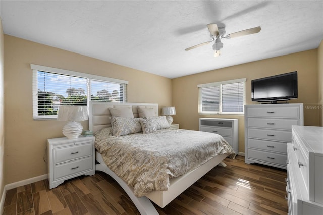 bedroom with dark wood-style floors, ceiling fan, a textured ceiling, and baseboards