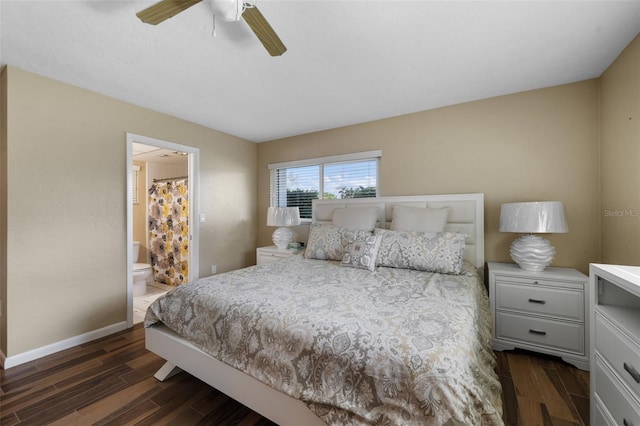 bedroom with dark wood-type flooring, ensuite bath, a ceiling fan, and baseboards