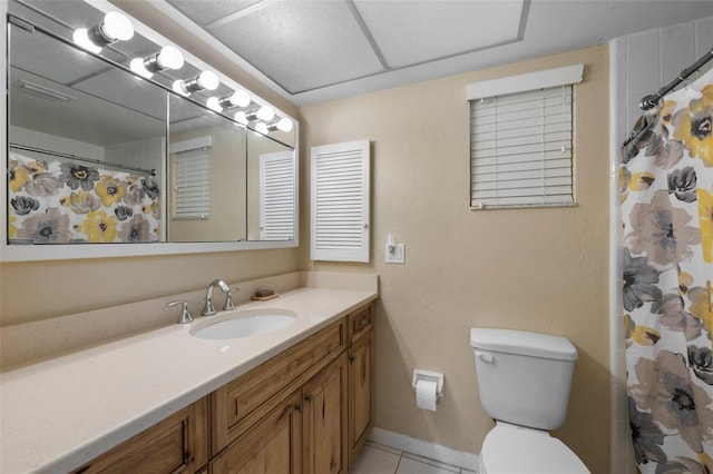 bathroom with a shower with shower curtain, toilet, vanity, tile patterned flooring, and baseboards