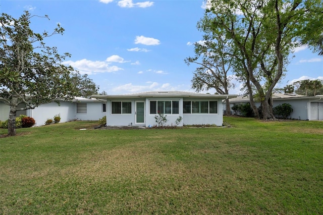 view of front of property with a front yard and stucco siding