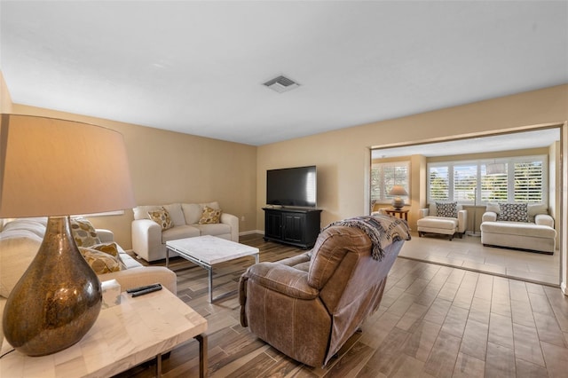 living room with light wood-type flooring and visible vents