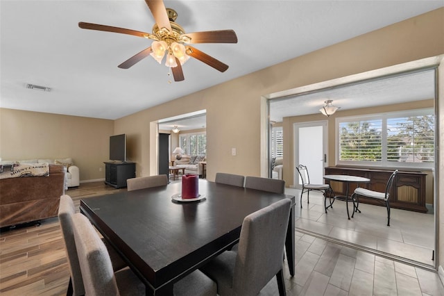 dining room featuring a wealth of natural light, visible vents, and light wood finished floors