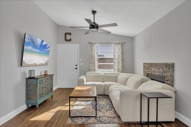 living room featuring a fireplace, dark wood-type flooring, ceiling fan, and lofted ceiling