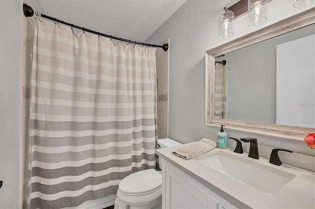 bathroom featuring a shower with curtain, vanity, toilet, and a textured ceiling