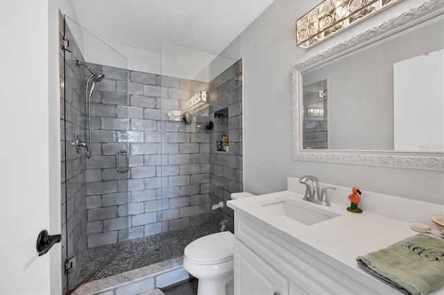 bathroom featuring vanity, toilet, and walk in shower