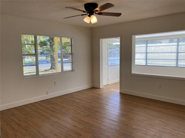 unfurnished room featuring ceiling fan and hardwood / wood-style floors