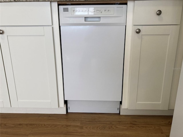 room details featuring white cabinets, dark hardwood / wood-style flooring, and dishwasher