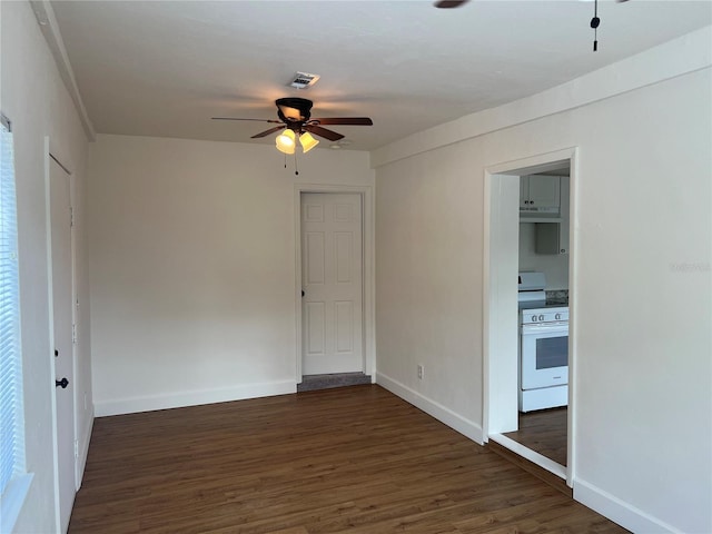 spare room with ceiling fan and dark hardwood / wood-style floors